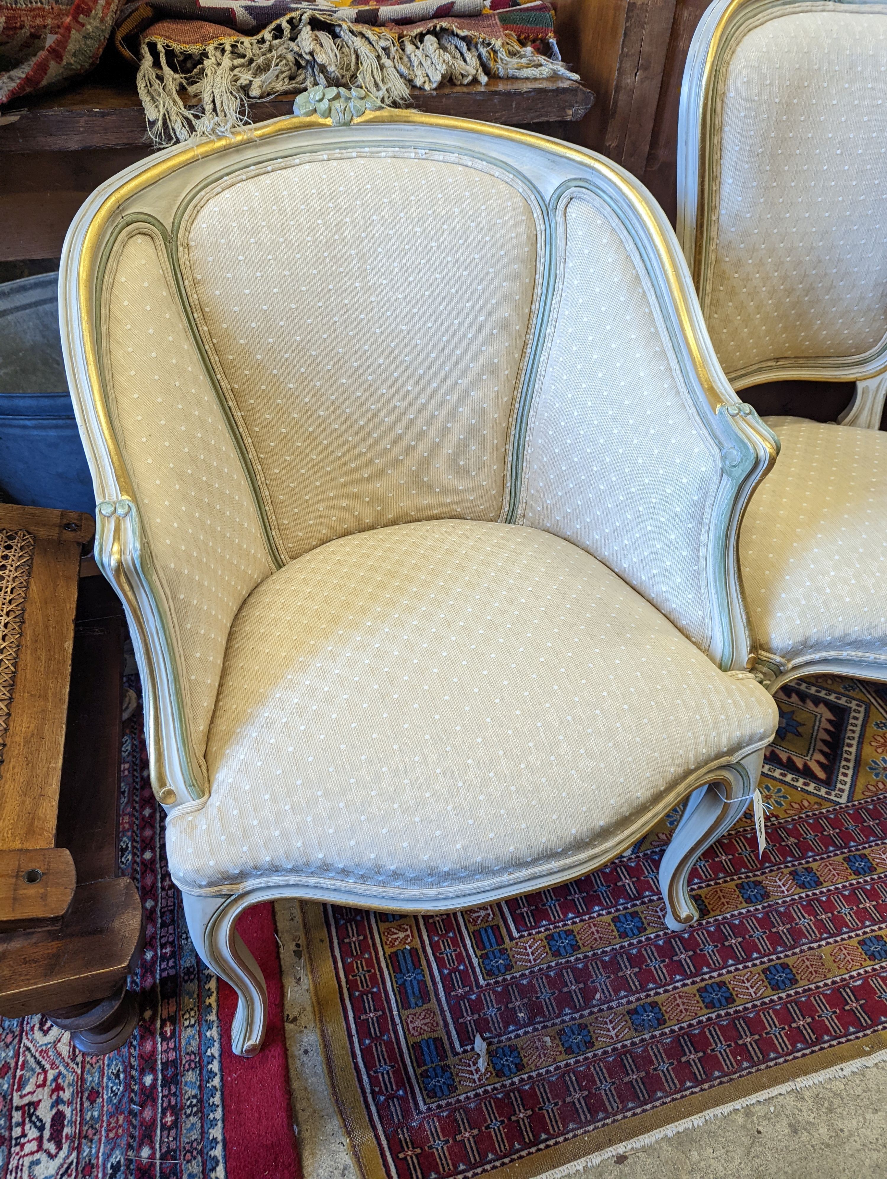 A Louis XVI style painted upholstered tub chair and a similar side chair